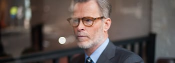 bearded model wearing glasses and suit with tie