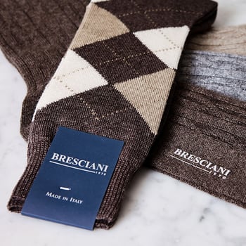 brown and beige bresciani socks laying on top of each other